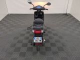 a motor scooter that is parked in a room