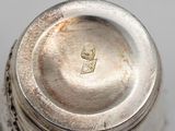 a silver container with a silver lid on a table
