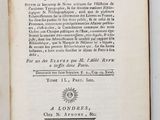 a book open on a white surface with a black and white image