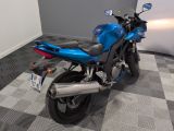 a blue motorcycle parked on a checkered floor