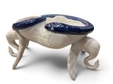 a crab figurine with a blue shell on it ' s legs
