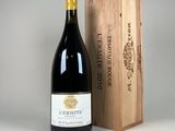 a bottle of wine sitting next to a wooden box