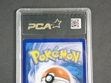 a close up of a pokemon card on a table with a black background
