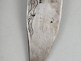 a knife with a drawing on it sitting on a table
