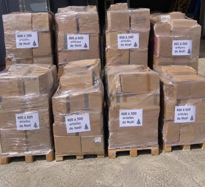 several stacks of cardboard boxes are stacked on pallets in a warehouse