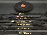 a suitcase that has a bunch of ties and a hat on it