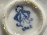 a close up of a plate with a blue and white design