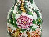 a vase with a bird and flowers painted on it