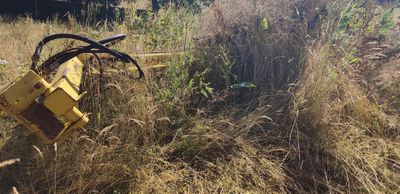 a yellow machine that is sitting in the grass