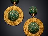 a pair of green and gold earrings