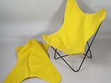 a yellow chair and a yellow umbrella on a white background