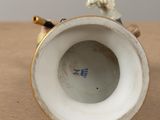a close up of a vase with a rope on it