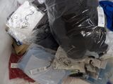 a pile of clothes and other items in a plastic bag