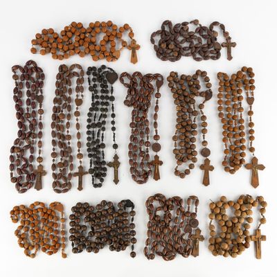 a close up of a bunch of rosary beads on a white surface