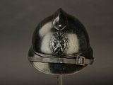 a silver helmet with a lion on it on a stand