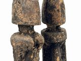 two figurines that are standing next to each other