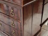 a dresser with a mirror on top of it in a room