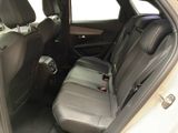 the back seats of a white car with a black seat belt