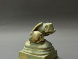 a close up of a statue of a dog with a skull on top of it