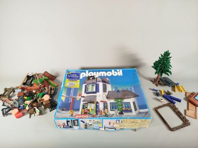 a box of playmobil with a bunch of toys on the table