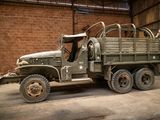 an old military truck with a large open cab
