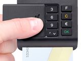 a person holding a credit card and a calculator