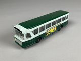 a green and white bus that is on a table