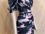 the mannequin is wearing a blue and white dress on a mannequin stand