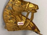 brass horse head with a bow on the back of it