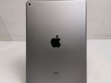 an apple ipad sitting on top of a table next to a white wall