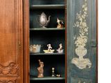 a cabinet that has a door open to reveal a cabinet with many items on it