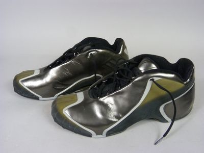 silver and black running shoes with black laces on a white surface