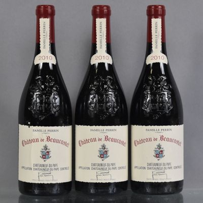 three bottles of red wine sitting on a table next to each other