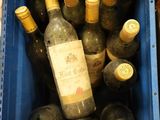 plusieurs bouteilles de vin dans une caisse bleue posée sur la table
