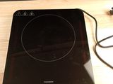 a black stove top with a black burner on it