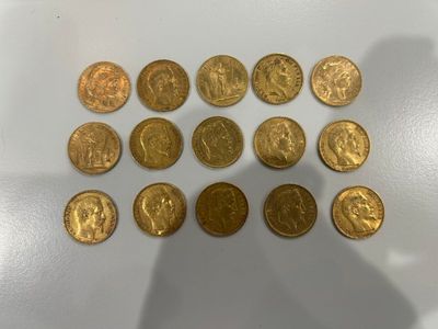 a bunch of gold coins sitting on top of a white surface