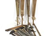 several different types of weapons are laid out on a white surface