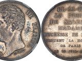 a close up of a coin on a white surface