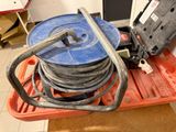 a blue reel on a red pallet with a black handle