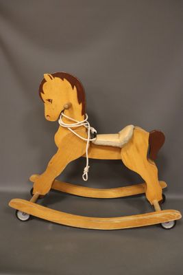 wooden rocking horse with a rope on the back of it