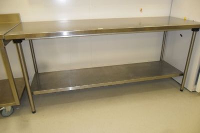 a stainless steel table in the middle of a room