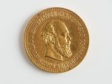 une pièce d'or sur laquelle figure l'image d'un homme