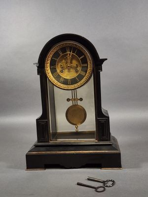 a clock that is sitting on a table next to a pair of scissors