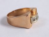 a close up of a gold ring with a diamond in it