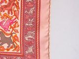 a pink and orange scarf with a picture of animals on it