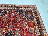 an image of a red and blue oriental rug on a blue floor