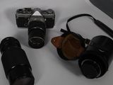 three cameras sitting on a table next to each other