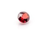 a red garnet stone on a white background