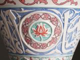 a close up of a decorative vase with a flower on it