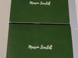 two green boxes with white writing on them sitting on a table